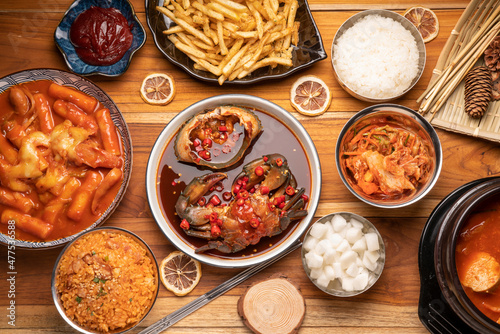 Korean traditional food Kimchi soup raw crabs in mild soy sauce Tteokbokki with rice and Kimchi pickle on wooden table,