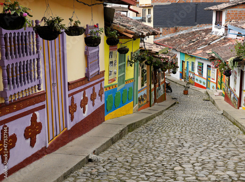 Guatape, Colombia: Calle del Recuerdos is a cobblestone pedestrian street that passes between colorful tile-roofed buildings decorated with zocalos (friezes) and hanging pots of flowers