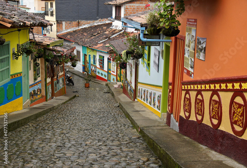 Guatape, Colombia: Calle del Recuerdos is a cobblestone pedestrian street that passes between colorful tile-roofed buildings decorated with zocalos (friezes) and hanging pots of flowers