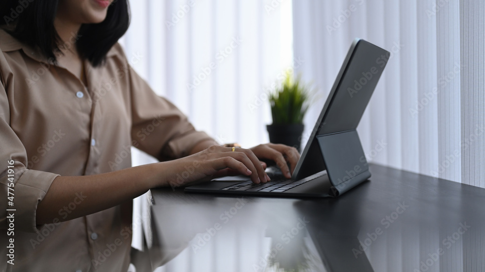 Female designer working with computer tablet in creative office