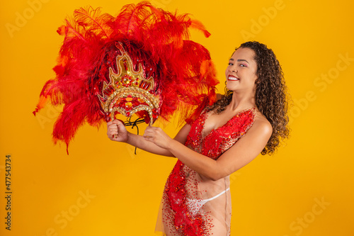 photo of afro woman dressed for carnival in dancer's outfit holding her crown in her hand. photo