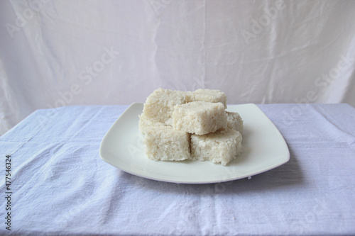white plate with milk rice on the white table