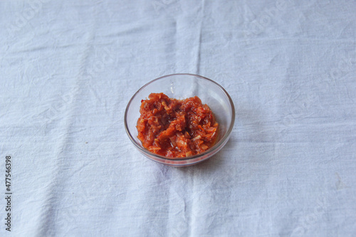 Lunu miris cup on the white background, hot chili pepper sauce paste