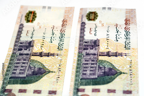 Selective focus of 200 LE two hundred Egyptian pounds banknote, obverse side has image of mosque of Qani-Bay Cairo, Egypt, reverse side has an image of the seated scribe isolated on white background photo