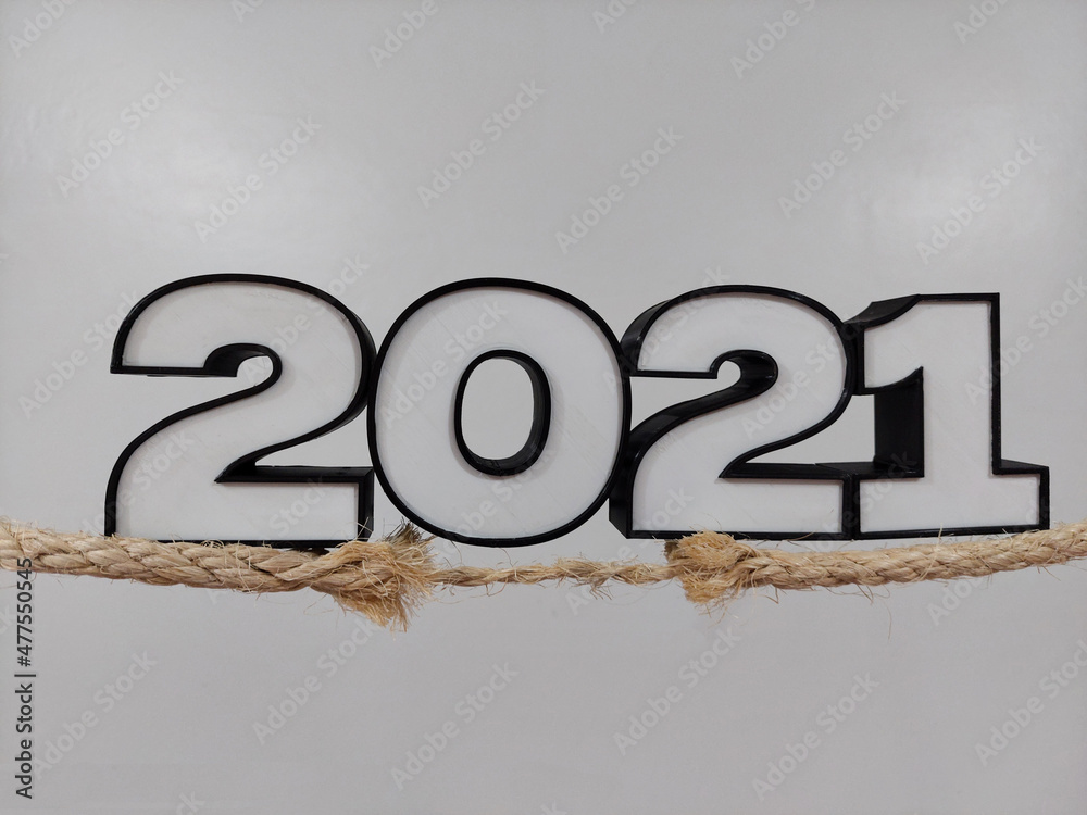 year 2021 coming to an end, standing on a rope almost breaking