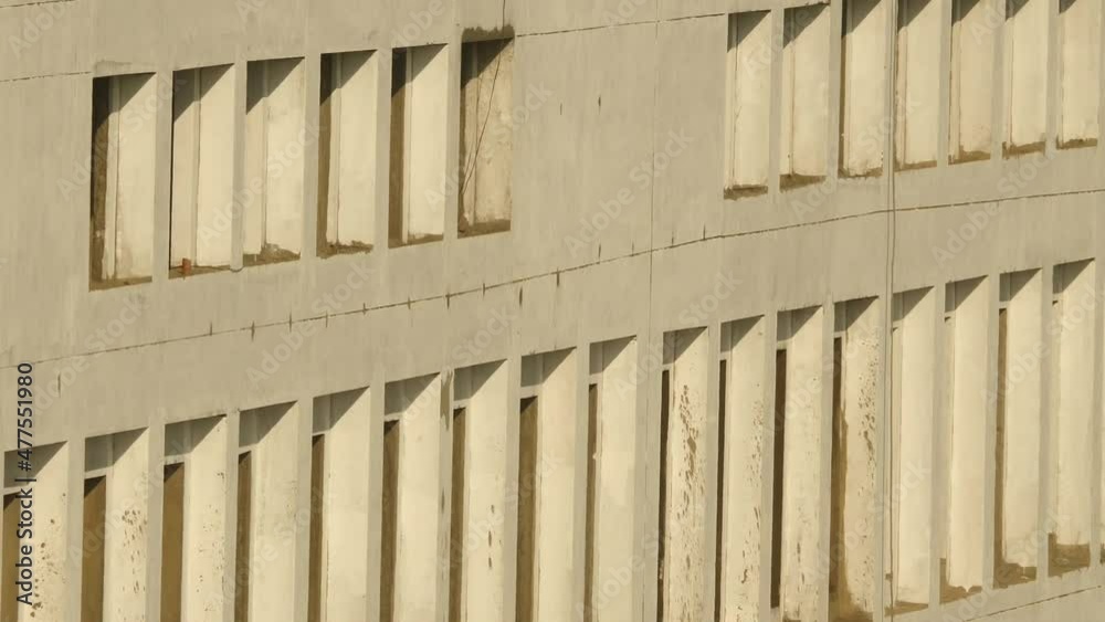 Side View Of Construction Building With Large Window Openings. Slow Zoom Out Side View Of Construction Building With Large Window Openings. Slow Zoom Out
