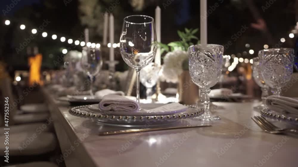An elegant table at night, set up for a banquet. An elegant table at night, set up for a banquet.