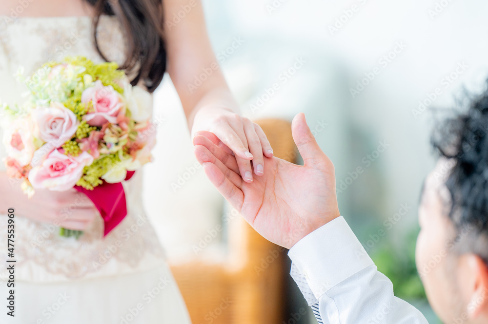 Close-up of the bride being escorted and the groom's hand Close-up of the bride being escorted and the groom's hand