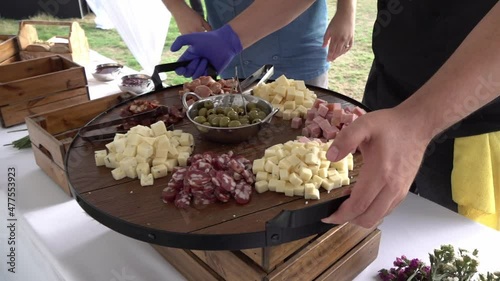 A chef presenting a charcuterie board for a social event. photo