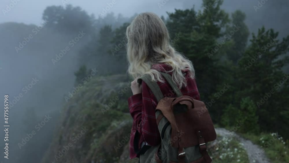Girl hipster traveler with backpak on rock in forest among fog. High quality FullHD footage Girl hipster traveler with backpak on rock in forest among fog. High quality FullHD footage
