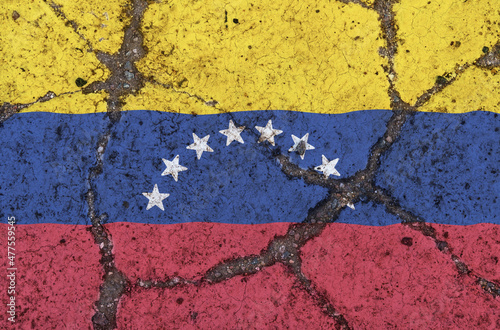 Venezuela flag on cracked asphalt. The concept of crisis, default, pandemic, conflict, terrorism. Out of focus image