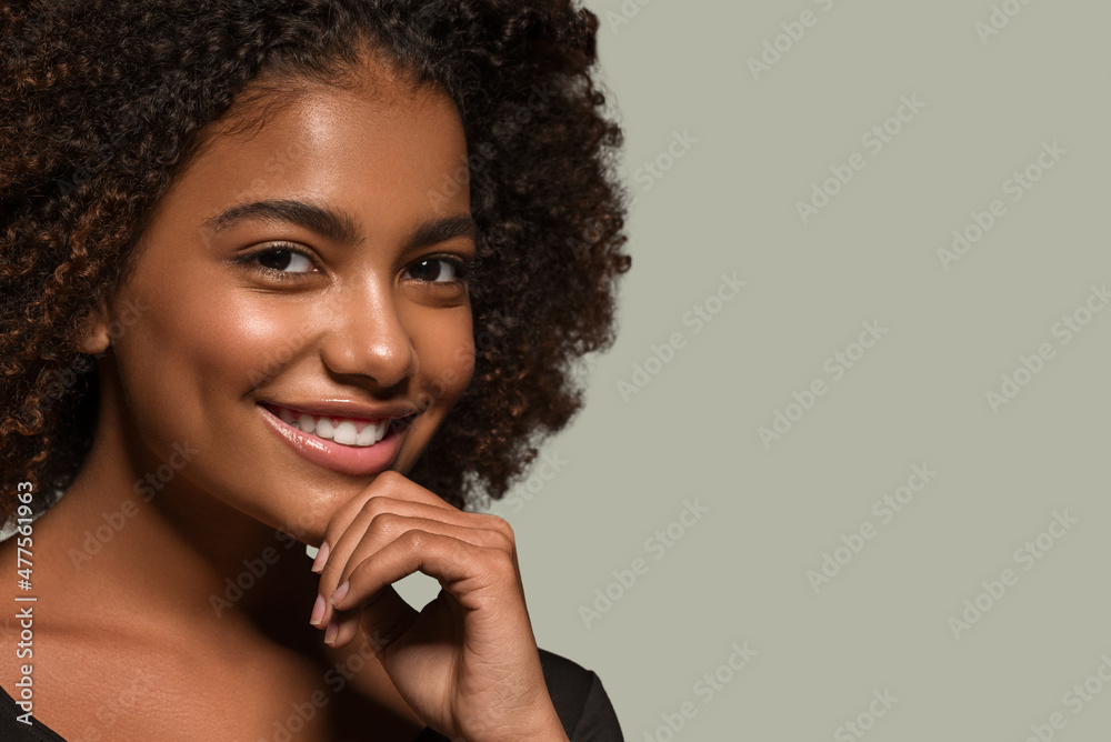 Beautiful african woman black t-shirt portrait afro haircut touching her face Color background green Beautiful african woman black t-shirt portrait afro haircut touching her face Color background green