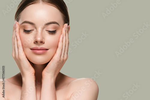 Skin care woman with hands portrait  skin closeup cosmetic age concept. Color background green photo