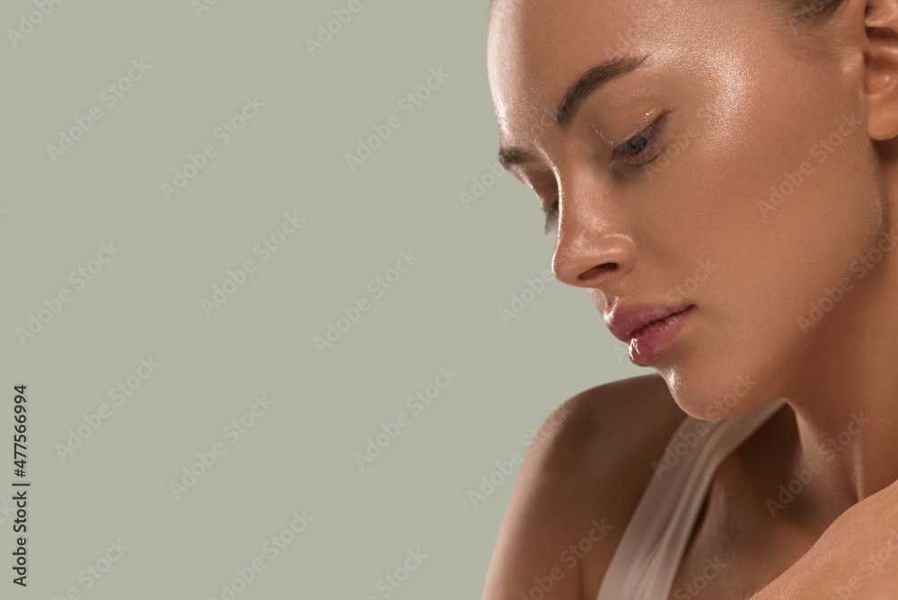 © Utkamandarinka - Beauty woman with hands healthy  natural make up clean fresh skin concept color background green