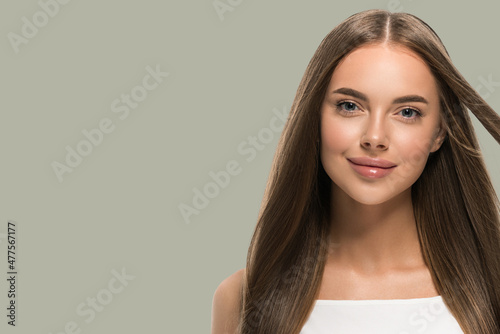 Beautiful woman with beautiful long smooth flying hair in white dress over color background green