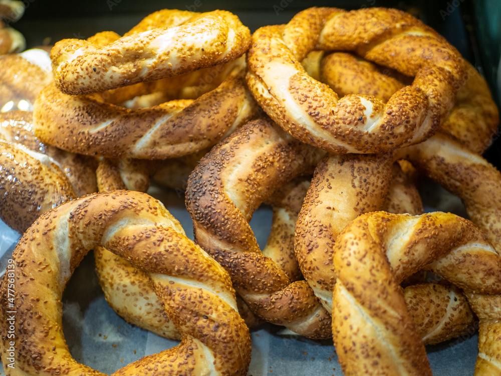 Simit - turkish bagels sprinkled with sesame seeds are sold in a shop window. Close-up.