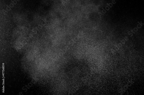 White powder explosion on black background. Abstract white dust texture.