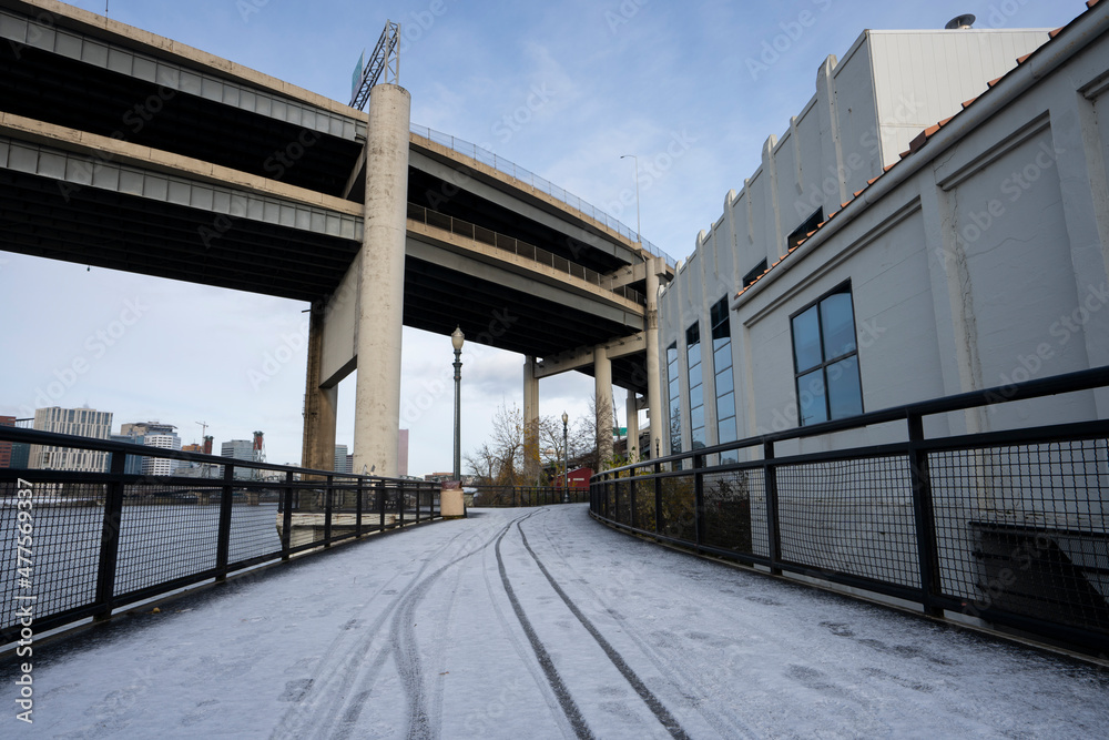 Eastbank Esplanade, a pedestrian and bicycle path along the east shore of the Willamette River in Portland, Oregon, on a cold winter morning after snowfall.