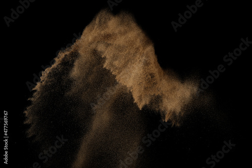 Sandy explosion isolated on black background. Abstract sand cloud.