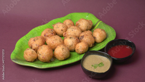 Delicious Indian snacks Punugulu served in a plate with Tomato and green Chutney photo