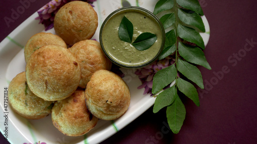 Appum or Appe, Appam or Mixed dal or Rava Appe served with green   chutney. A Ball shape popular south Indian breakfast dish, Selective focus
 photo