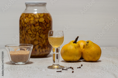 Homemade quince liqueur. Maceration of quinces in water, cane sugar, cinnamon, cloves and alcohol.