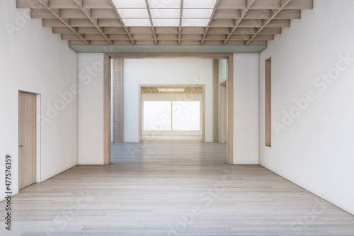 Contemporary concrete exhibition hall interior with wooden flooring, empty posters and sunlight. Gallery concept. 3D Rendering.