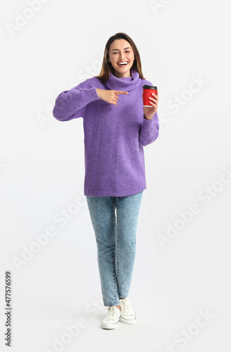 Smiling young woman in purp...
