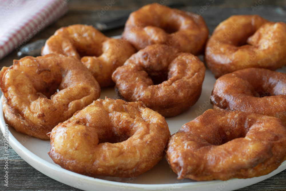 Homemade fresh deep fried cruller on a plate Homemade fresh deep fried cruller on a plate