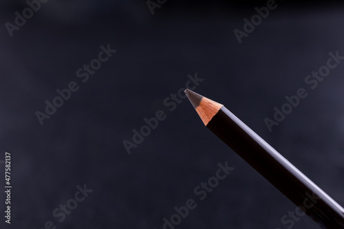 close-up of powdery eyebrow pencil on a black background photo