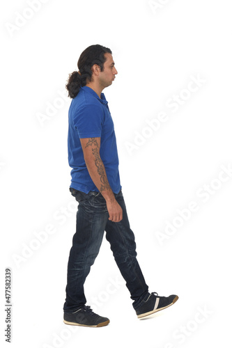 side view of a man dressed in casual clothes with tattoos on white background