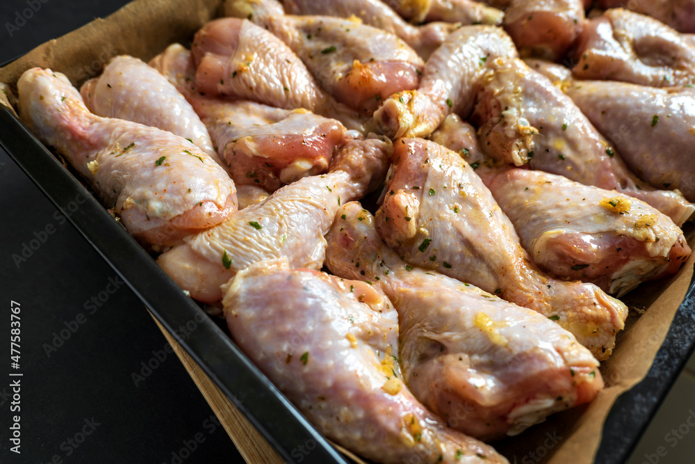 raw chicken drumsticks on baking tray prepared for oven raw chicken drumsticks on baking tray prepared for oven