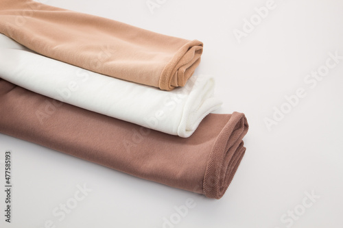Rolls of bright colored fabric on a white background.