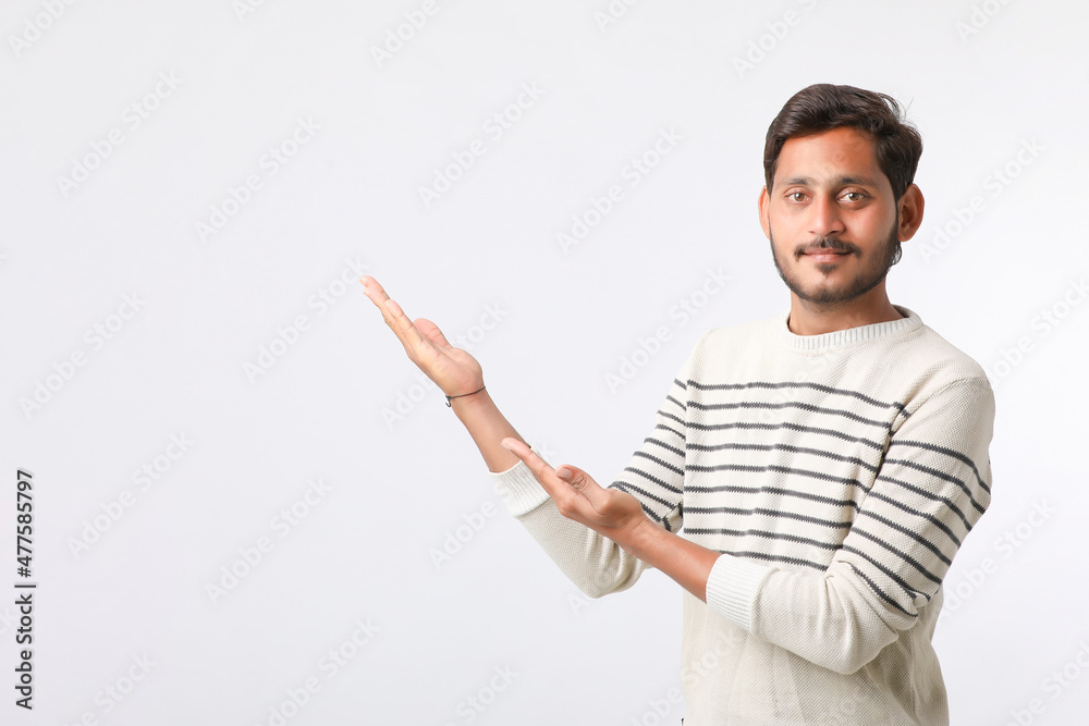 Young indian man giving expression on white background. Young indian man giving expression on white background.