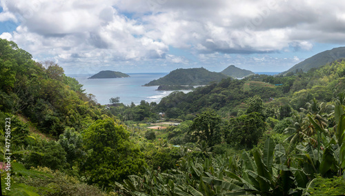 High-resolution panoramic photography. Mountain jungle landscape. High hills covered with impenetrable jungle. The skies with dense clouds. In the distance is endless ocean