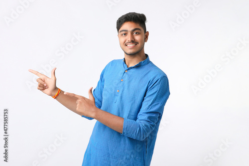 Indian man in tradition wear and giving expression on white background.