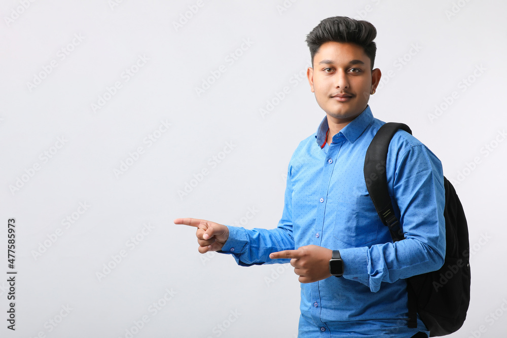 Young indian college student giving expression on white background. Young indian college student giving expression on white background.