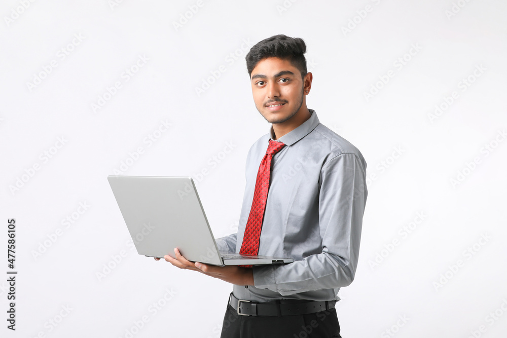 Young indian man using laptop on white background. Young indian man using laptop on white background.
