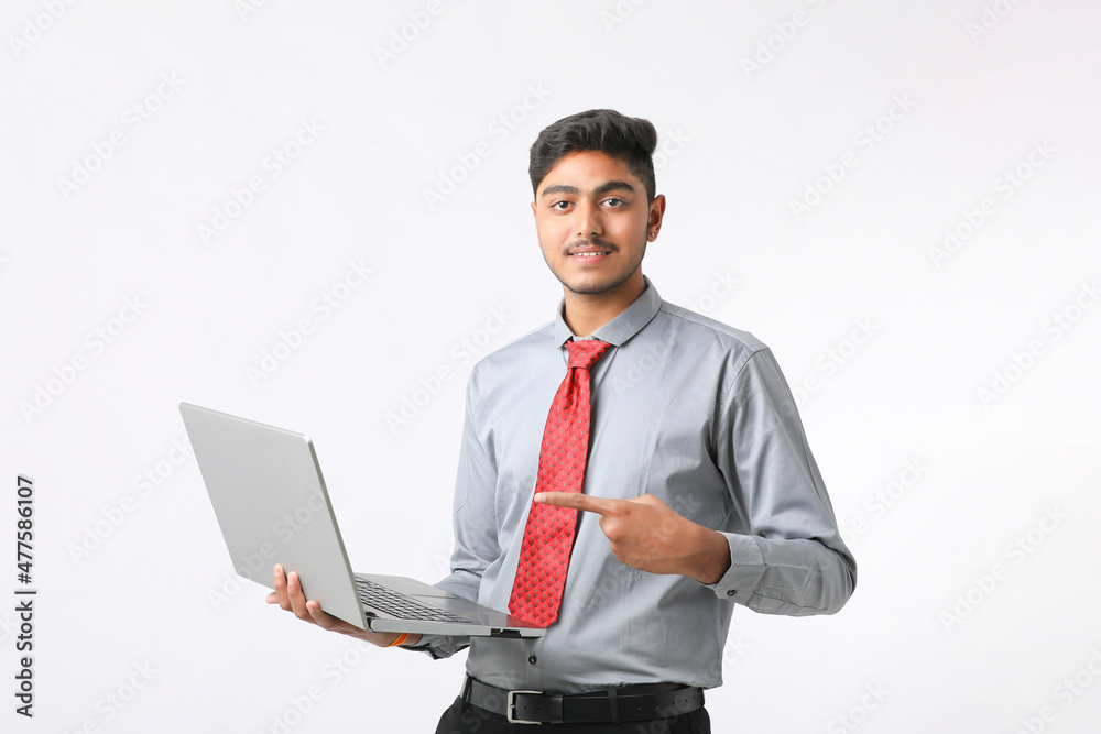 Young indian man using laptop on white background. Young indian man using laptop on white background.