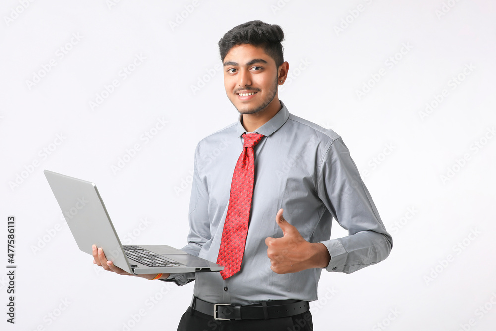 Young indian man using laptop on white background. Young indian man using laptop on white background.