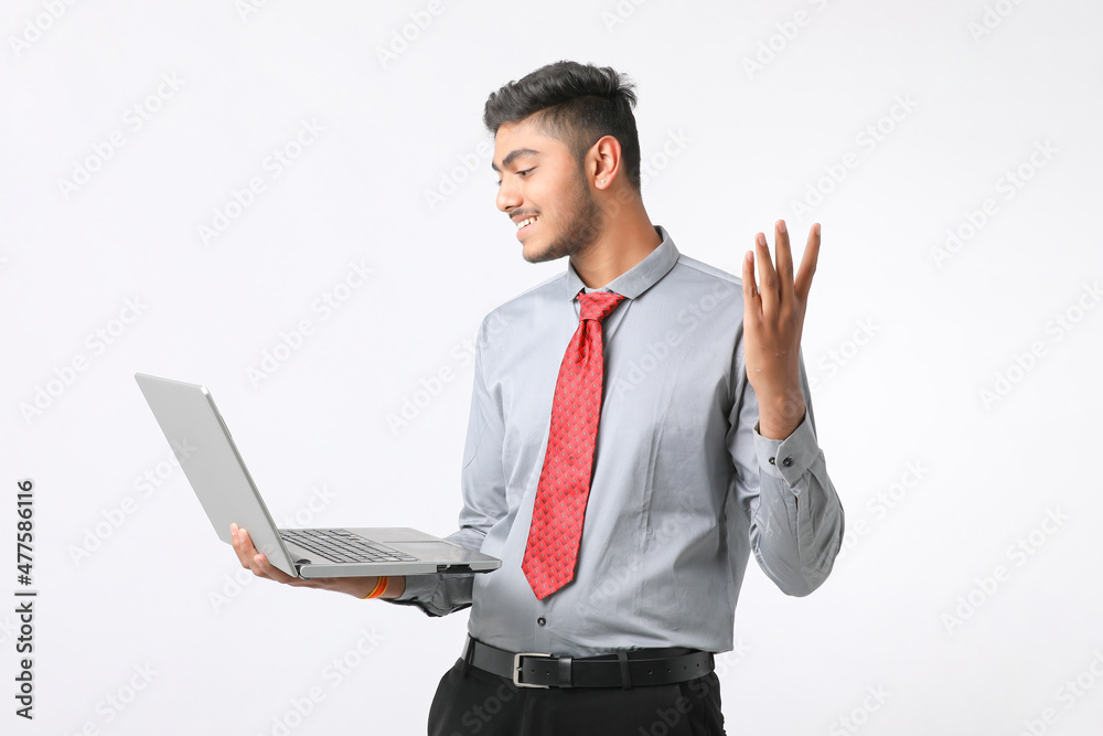Young indian man using laptop on white background. Young indian man using laptop on white background.