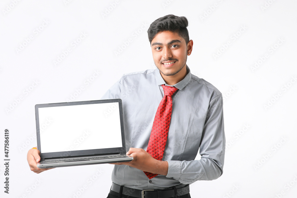 Young indian man showing laptop screen on white background. Young indian man showing laptop screen on white background.