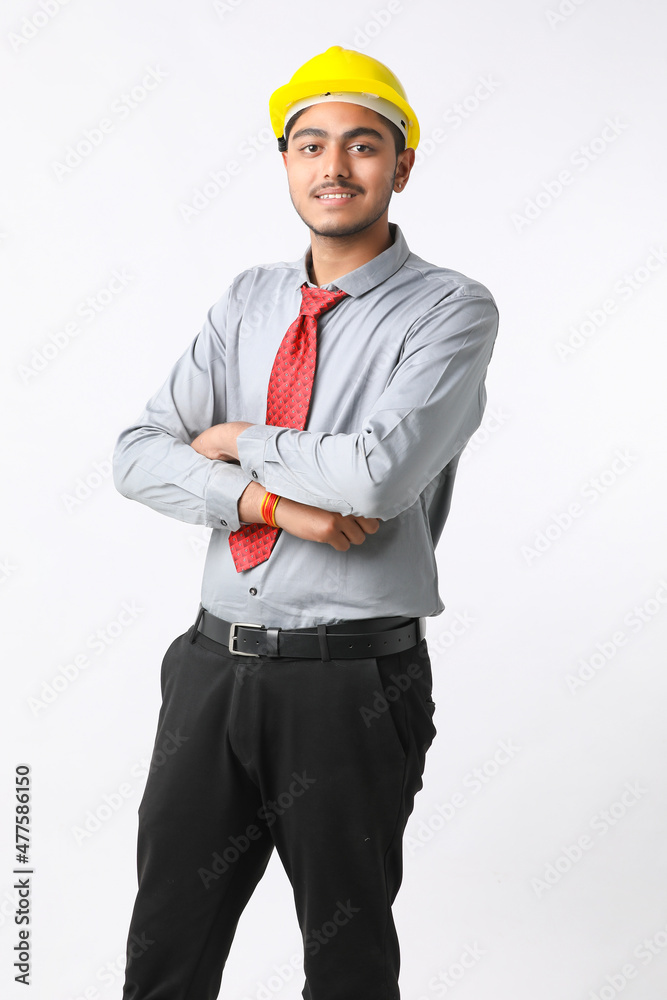 Young Indian engineer wearing yellow color hard hat and giving successful gesture. Young Indian engineer wearing yellow color hard hat and giving successful gesture.