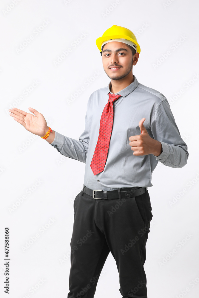 Young Indian engineer wearing yellow color hard hat and giving successful gesture. Young Indian engineer wearing yellow color hard hat and giving successful gesture.
