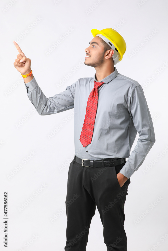 Young Indian engineer wearing yellow color hard hat and giving successful gesture. Young Indian engineer wearing yellow color hard hat and giving successful gesture.