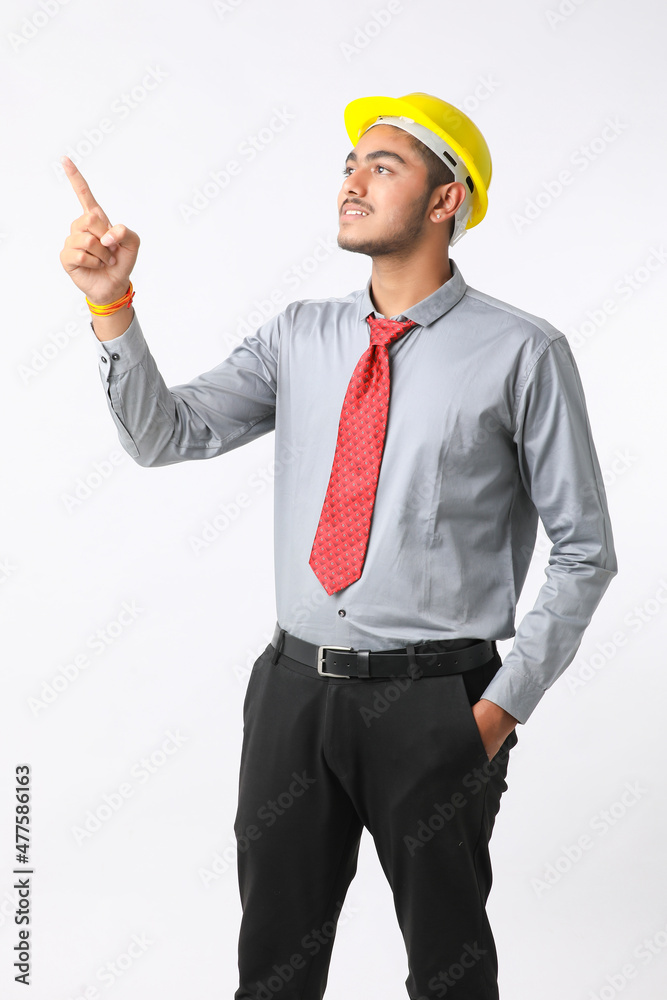 Young Indian engineer wearing yellow color hard hat and giving successful gesture. Young Indian engineer wearing yellow color hard hat and giving successful gesture.