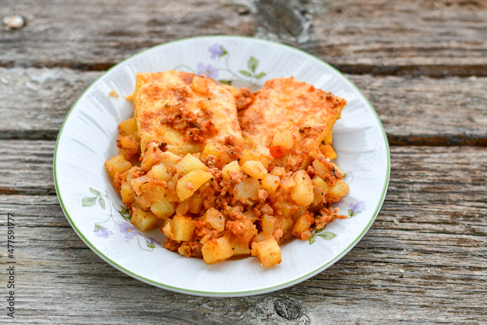 Potato and minced meat Casserole with parmesan cheese and garlic on wooden rustic bakcground. Bulgarian moussaka Potato and minced meat Casserole with parmesan cheese and garlic on wooden rustic bakcground. Bulgarian moussaka