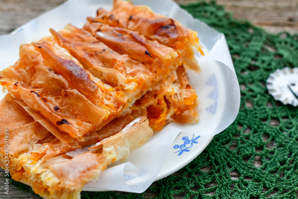 Pumpkin home made pie with filo pastry. Bulgariant banitsa. Spring background Pumpkin home made pie with filo pastry. Bulgariant banitsa. Spring background