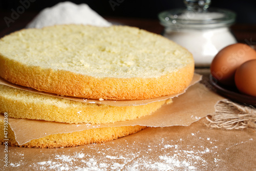 Cutting the biscuit into layers. Slicing sponge cake at home in the kitchen close up