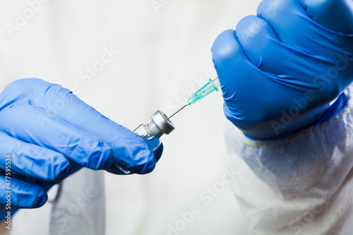 Closeup of syringe with needle in vaccine ampoule vial